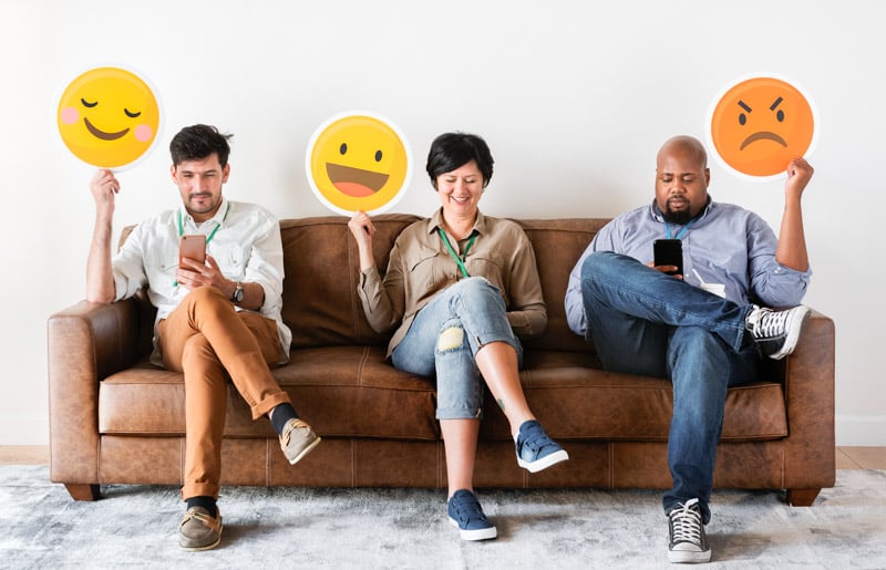 diverse-people-sitting-holding-emojis-logos