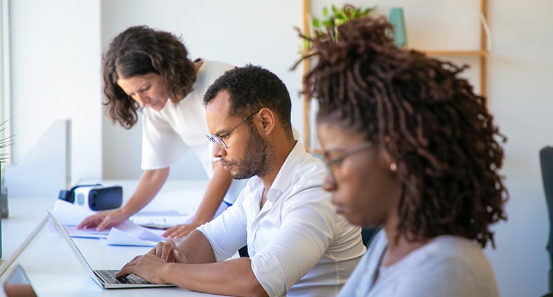 focused-young-man-eyeglasses-typing-laptop