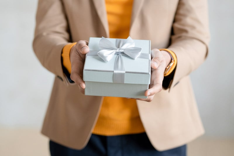 hands-young-elegant-businessman-with-packed-birthday-present-giftbox-passing-you-gift-blue-box-with-bow-made-up-silk-ribbon-2