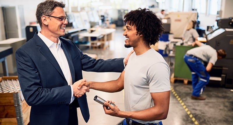 happy-manager-shaking-hands-with-factory-worker-industrial-building