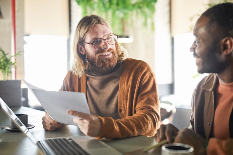 portrait-contemporary-bearded-man-smiling-colleague-partner-while-collaborating-during-business-meeting-green-office-interior-copy-space