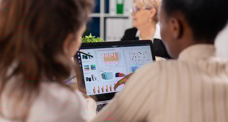 rear-view-team-looking-at-data