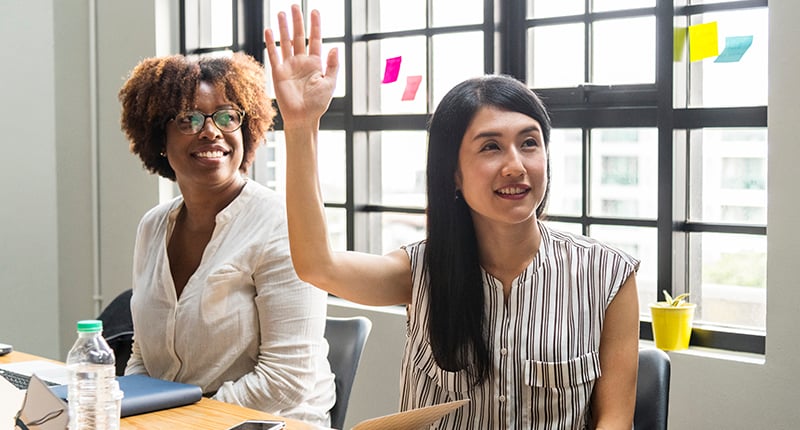 woman-business-meeting-raised-hand
