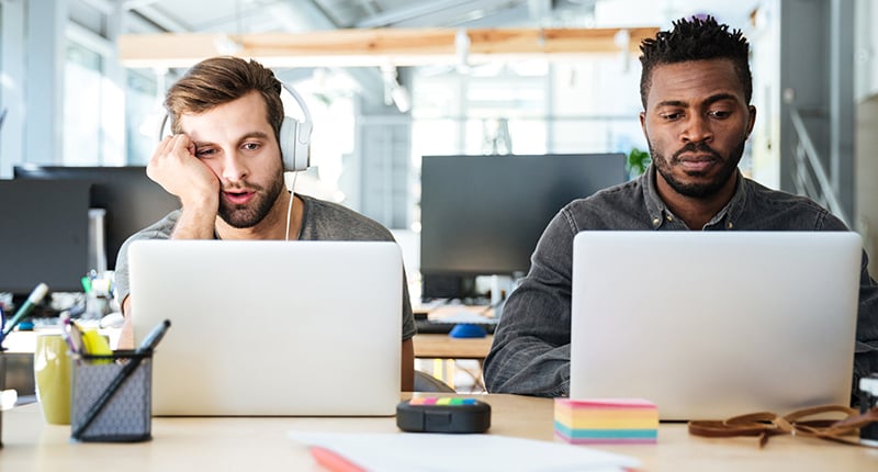 young-disengaged-colleagues-sitting-office-coworking