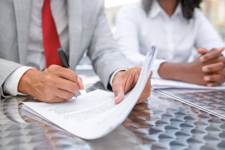 closeup-shot-businessman-signing-documents