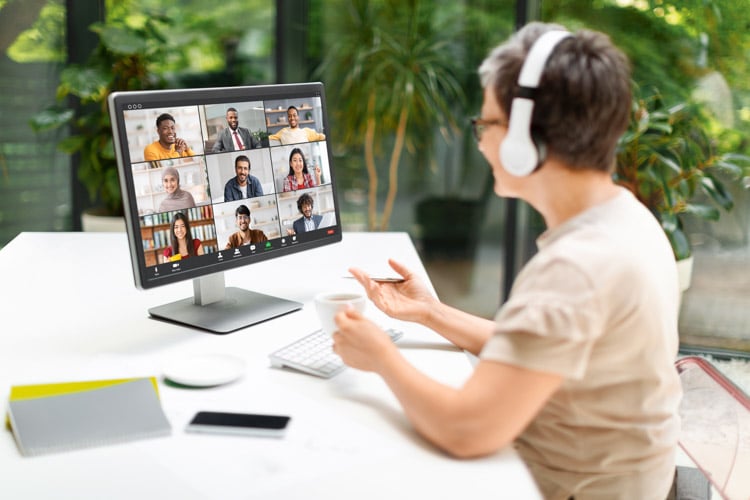 mature-woman-having-video-call-via-computer-home-office