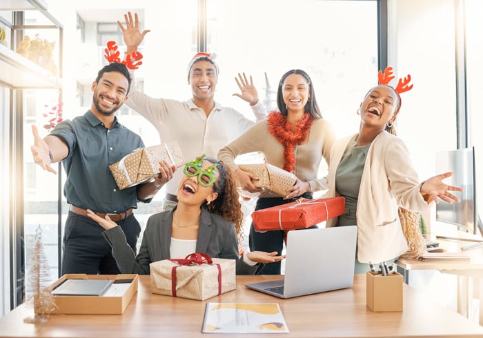 sharing-christmas-spirit-shot-group-businesspeople-celebrating-during-christmas-party-work-2